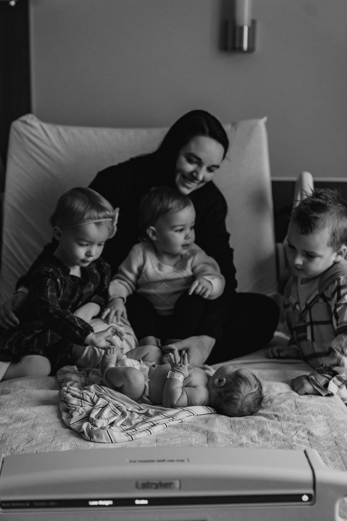 Mom with baby and older children at hospital 