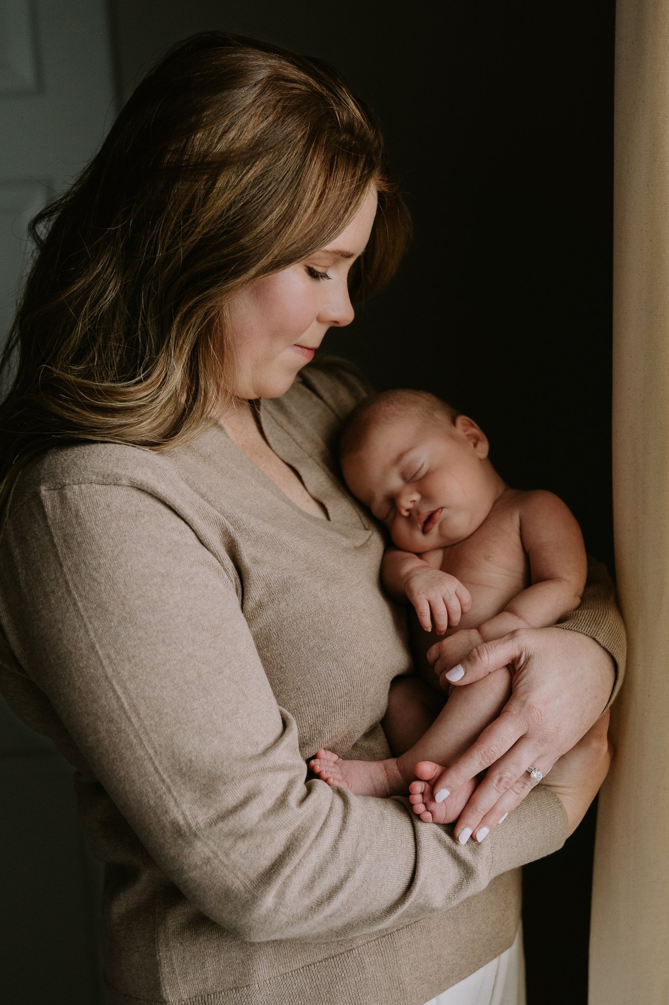 mom cradles newborn son