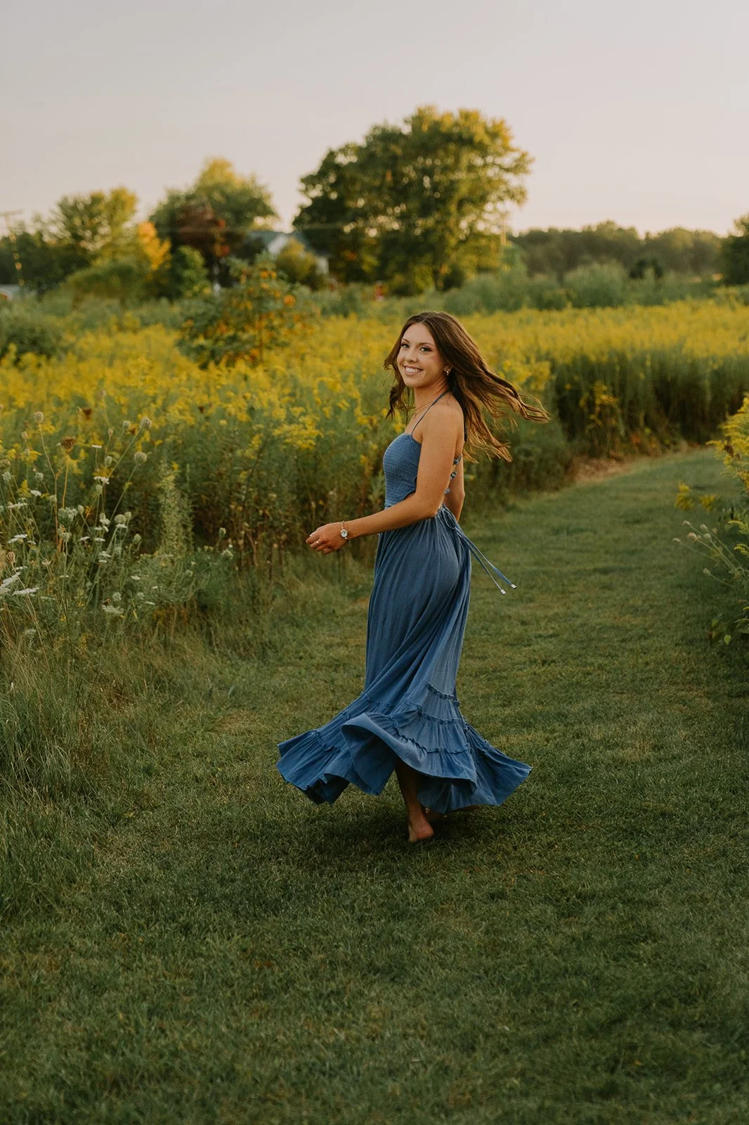 Indiana Senior Photography | Senior Running Through Meadow in Blue Dress