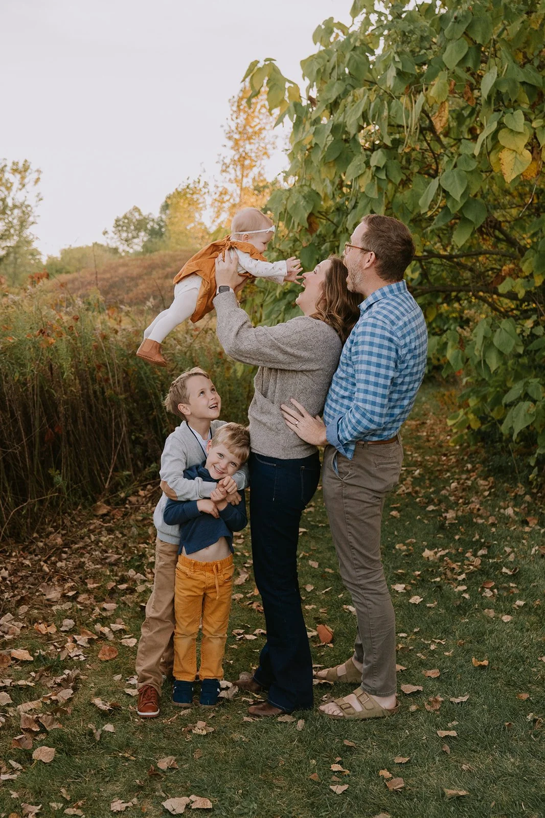 Mom Tossing Baby in Golden Light | Meadows Edge Minis