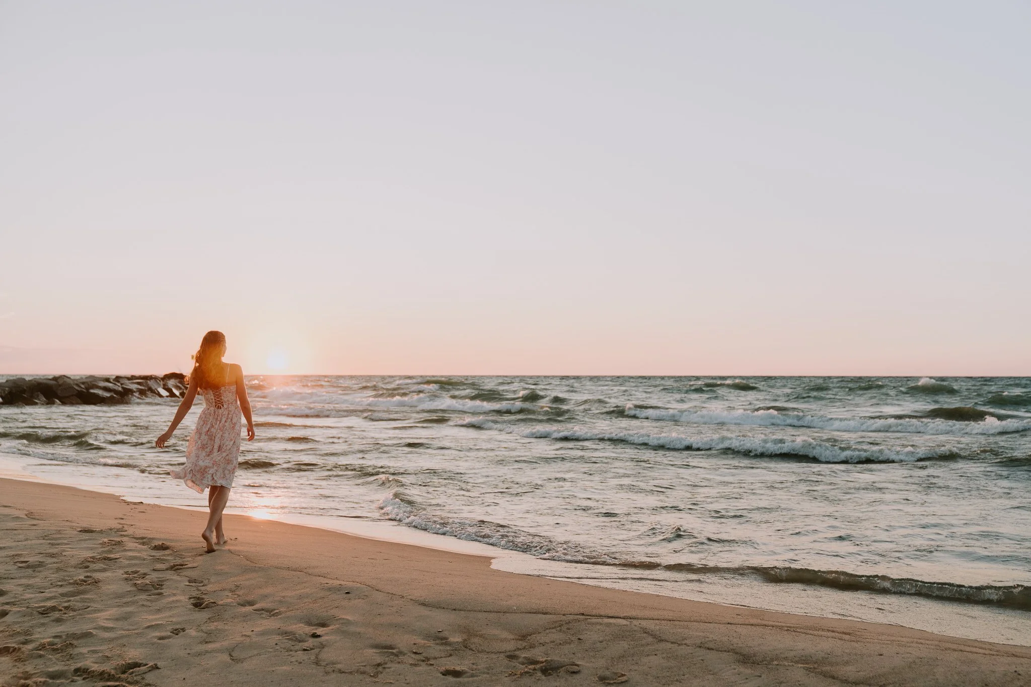 Senior walking into sunset at beach
