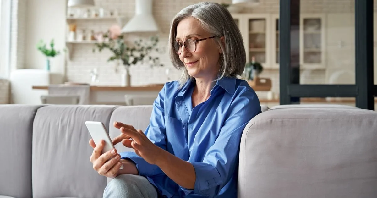 Senior woman using smartphone to access Social Security account