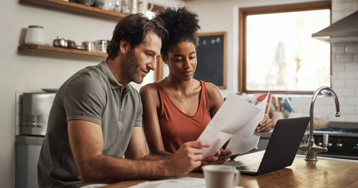 Couple comparing health insurance plans during open enrollment