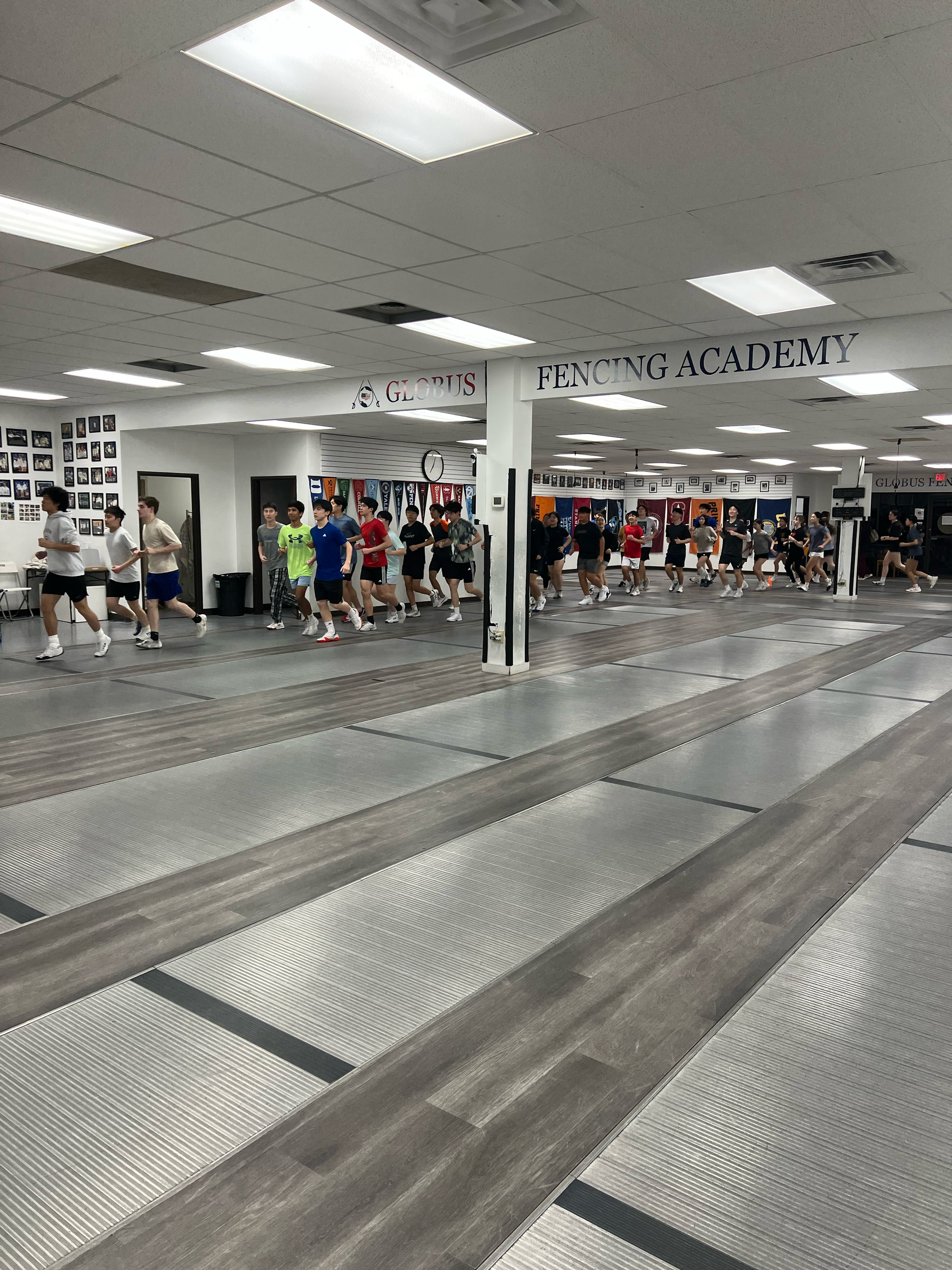 Students practicing fencing at a fencing academy.