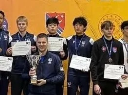 Group of male fencing athletes on the podium holding medals and certificates at the 2025 Summer Nationals in Milwaukee, Wisconsin.