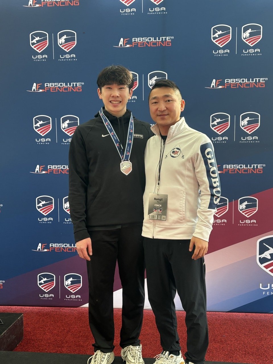 Group of medalists at the 2025 Summer Nationals in Milwaukee, Wisconsin, standing in front of a backdrop with logos. They are wearing medals and sportswear, and the photo lists their names and rankings in men's saber fencing.