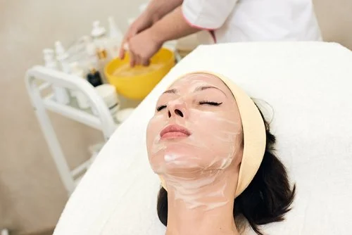 woman enjoys facial treatment