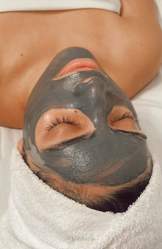 woman enjoying mud mask
