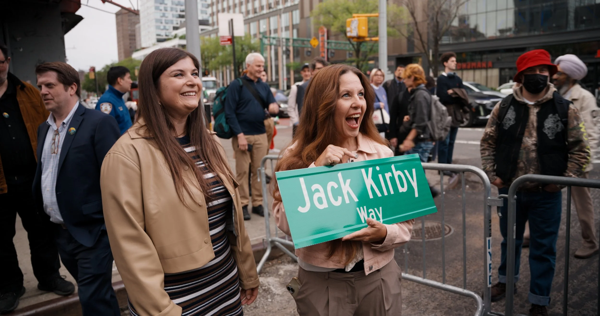 Kirby's familymembers hold replica of the unveiled sign.