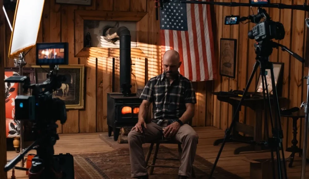 Bravo Film House interview setup with cinema cameras and lighting in a rustic cabin for a brand film