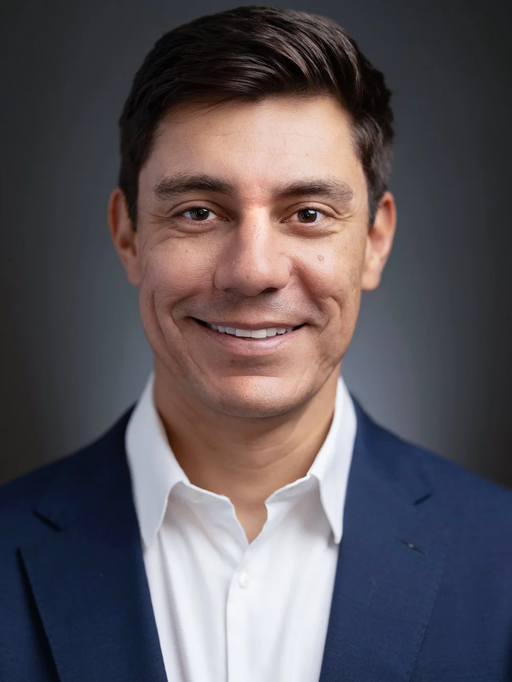 Executive headshot of a man in a navy blazer, Denver professional headshot by Draper Studios
