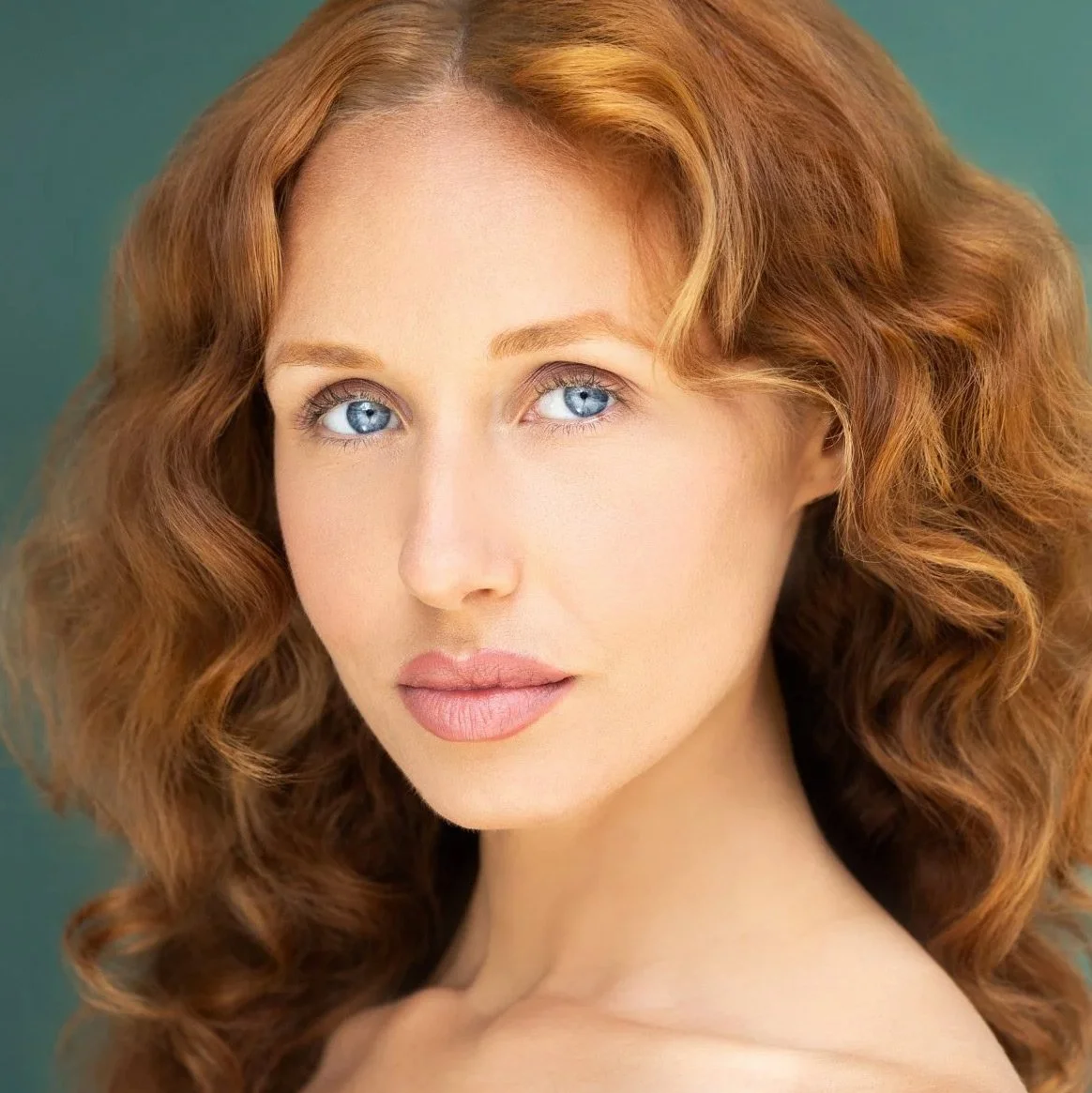 Close-up actor headshot of a woman with red hair photographed by Draper Studios