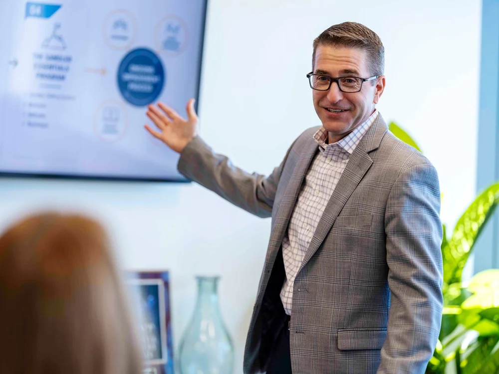 Sales trainer Michael P. smiling as he presents to a client during a personal branding session by Draper Studios in Denver