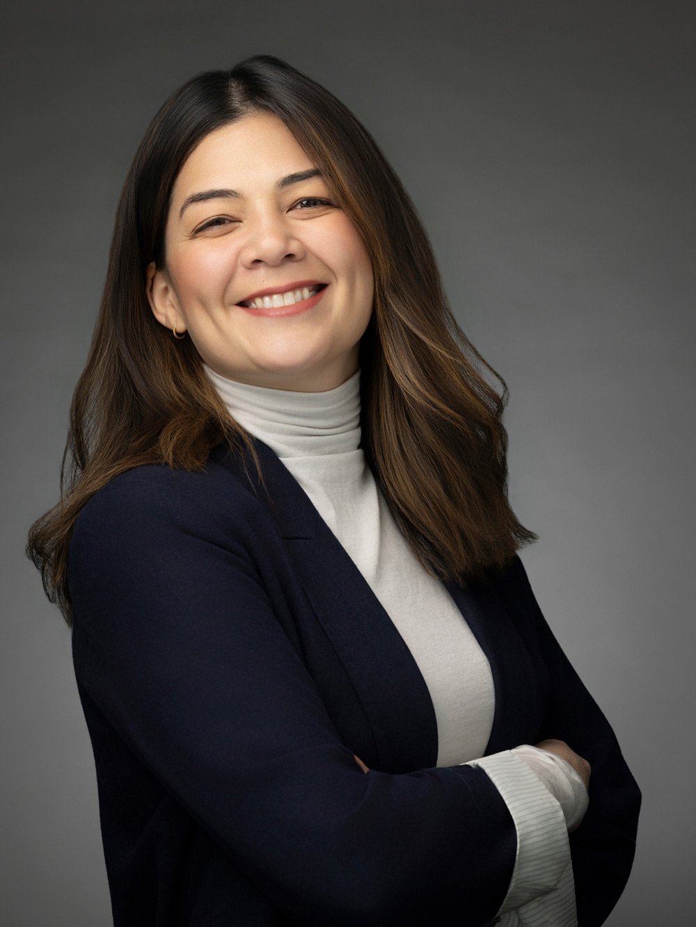 Corporate headshot of a woman in a navy blazer, Denver headshots by Draper Studios
