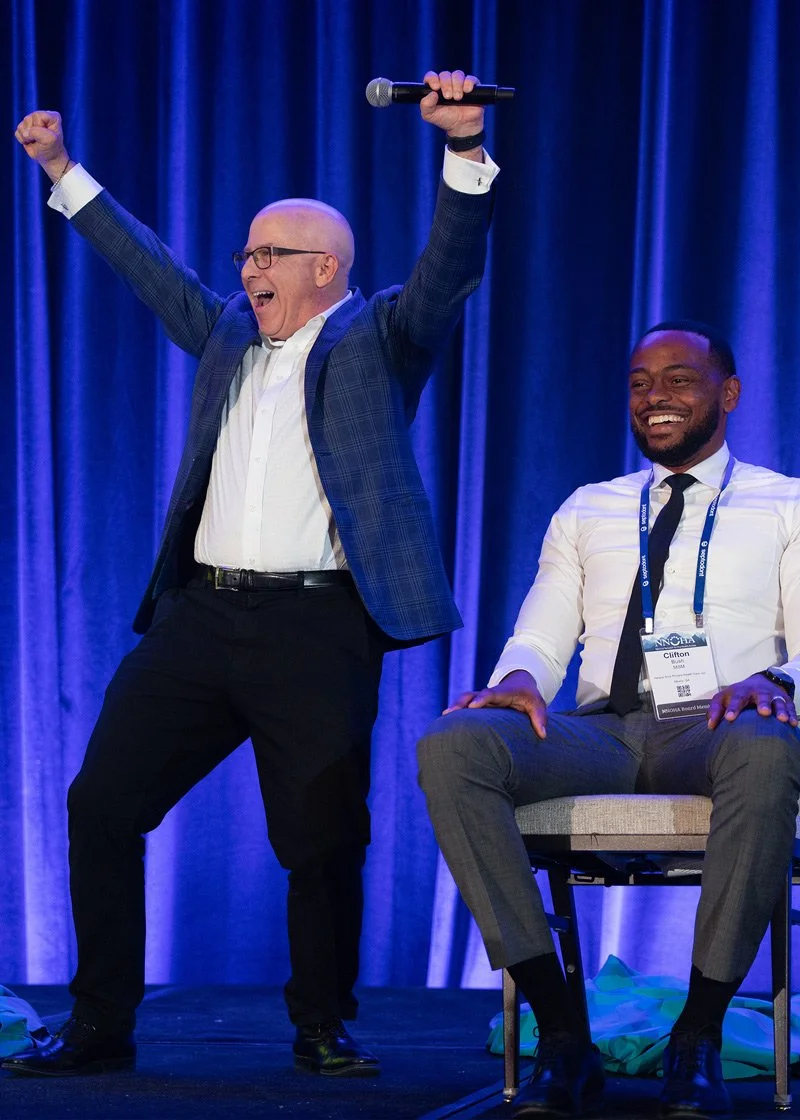 Corporate event photography of speakers on stage photographed by Draper Studios in Denver