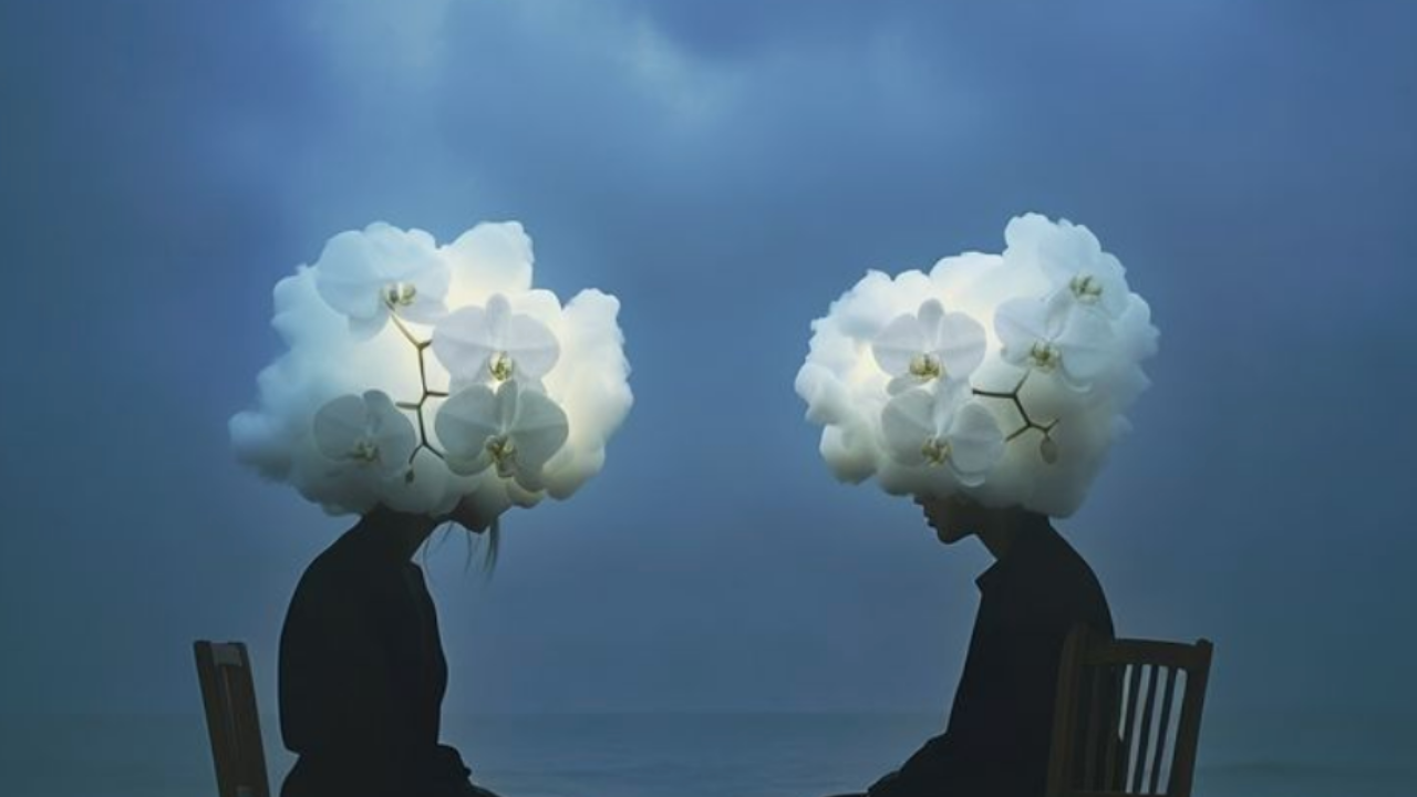 Two people sitting in chairs, facing each other, their heads are clouds.