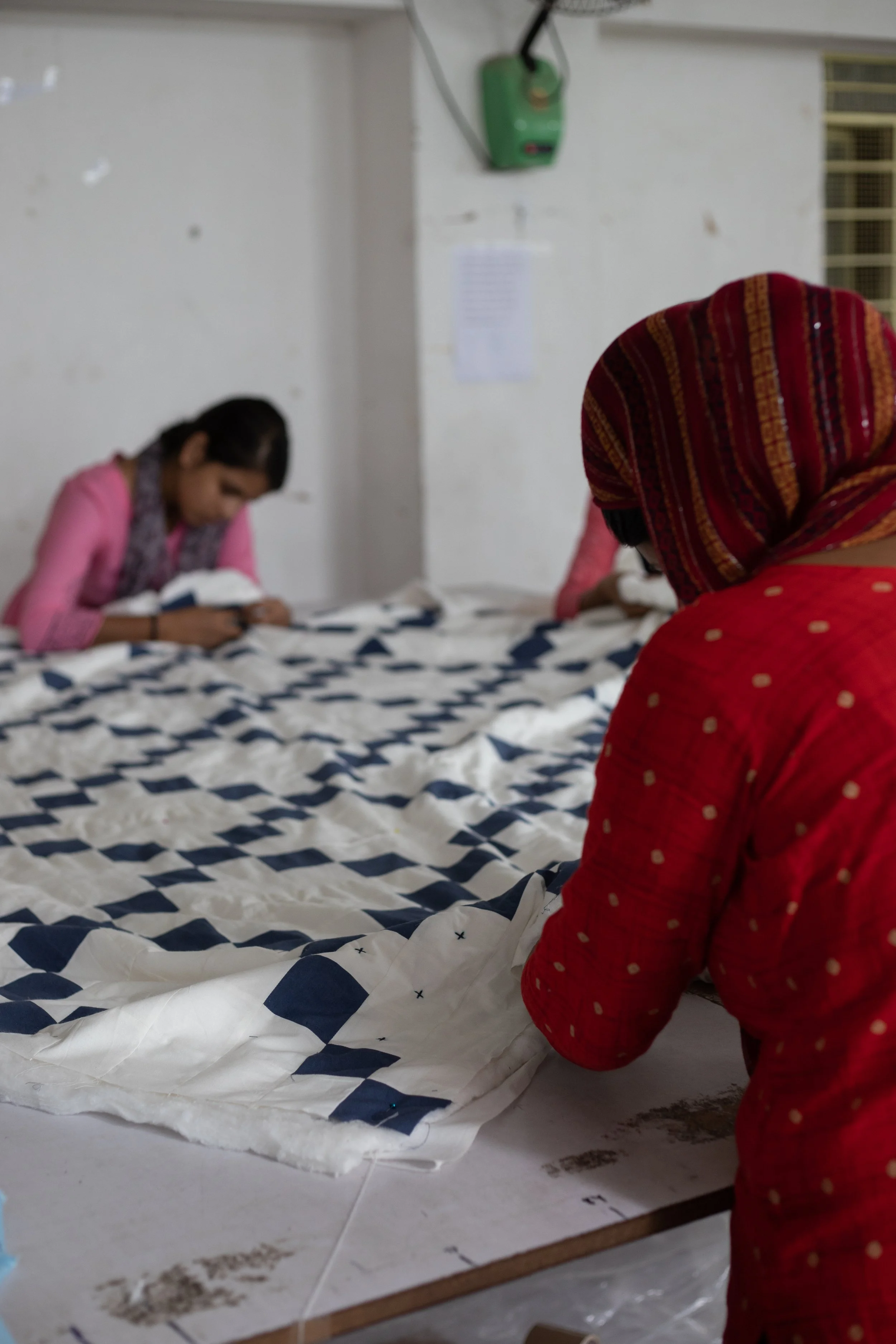 Women working together and quilting by hand in Jaipur.