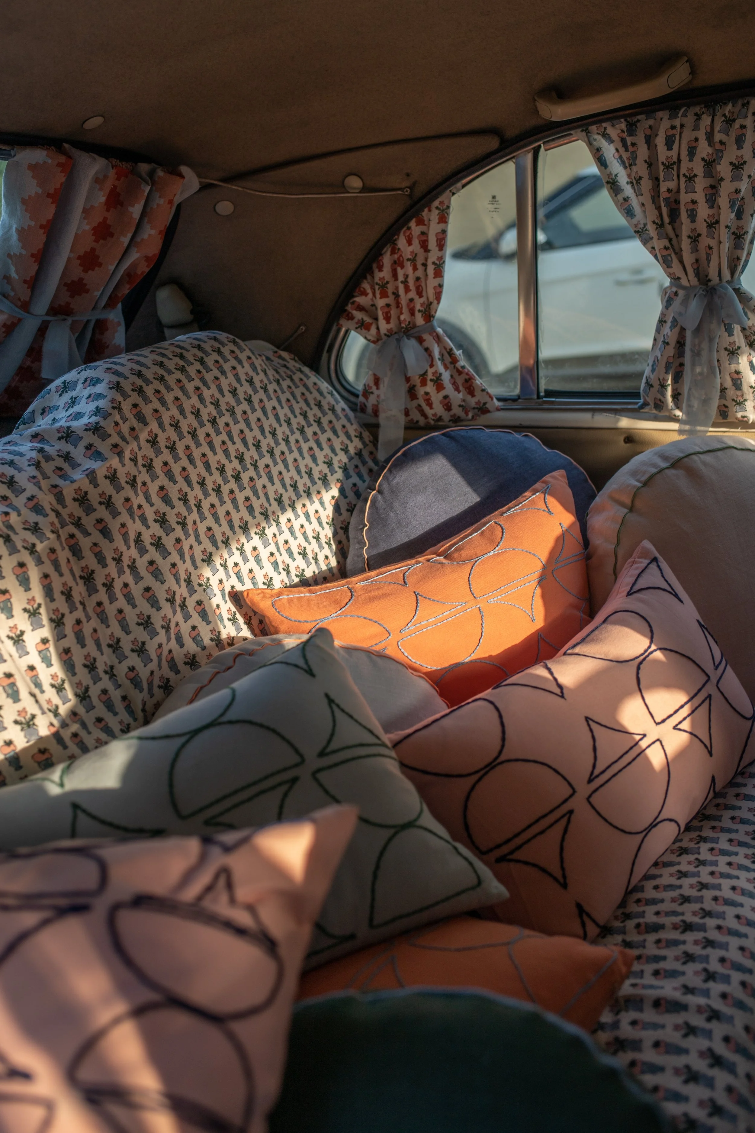 Cushions piled up in an ambassador in Jaipur.