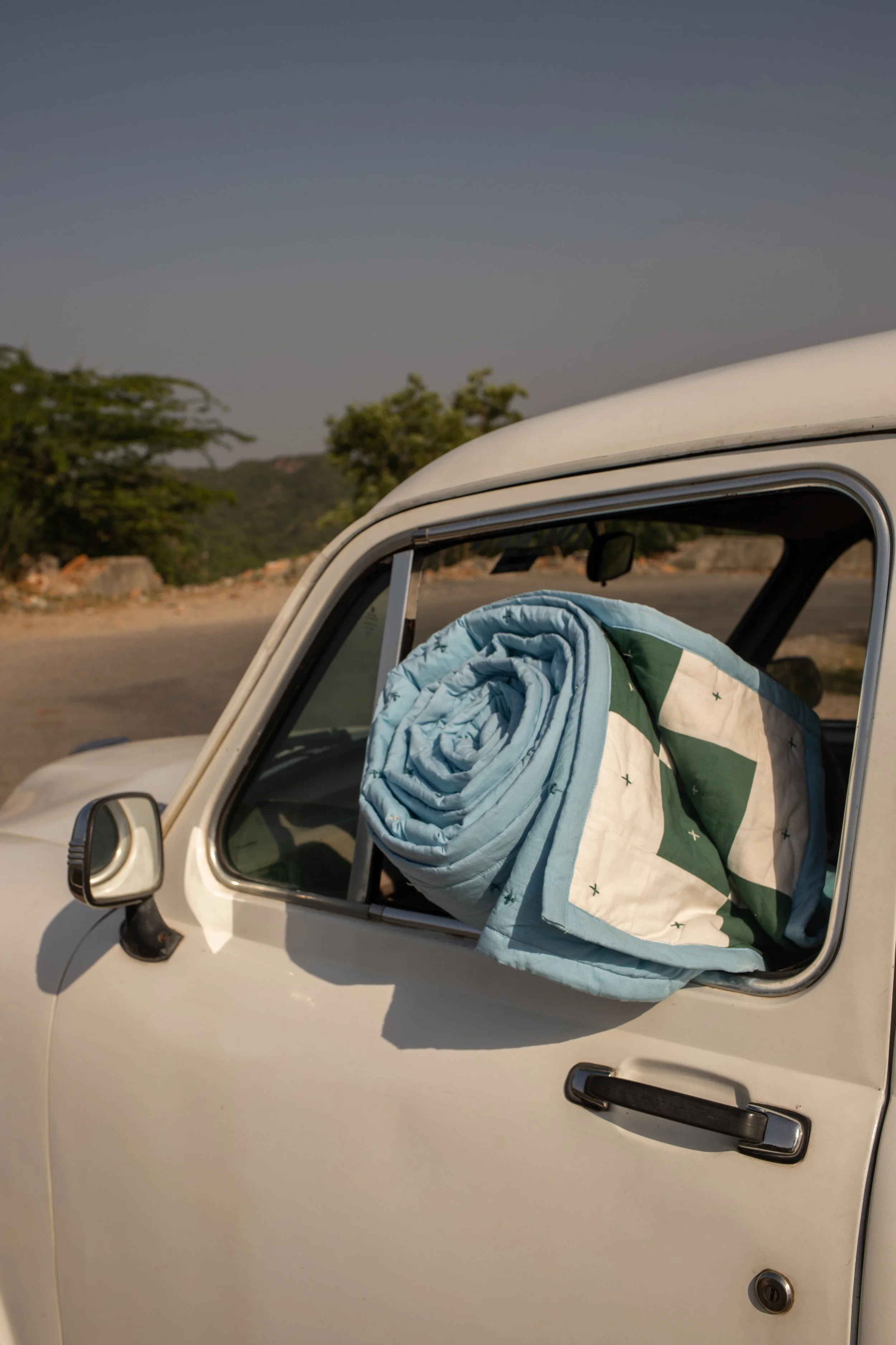 Our organic cotton Rani Quilt propped up in an ambassador.