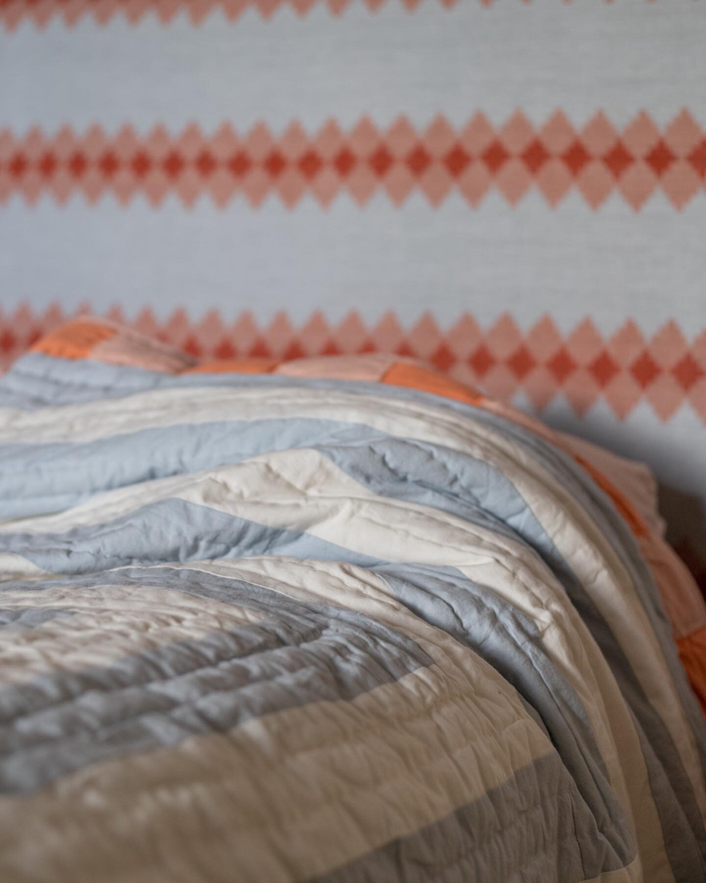 We only have one kantha quilt left! Don&rsquo;t hang around.

Crafted from a patchwork of organic cotton, concentric rectangles in pale blue pair joyously with a chequered border in terracotta and peachy pink, one of which carries through to the unde