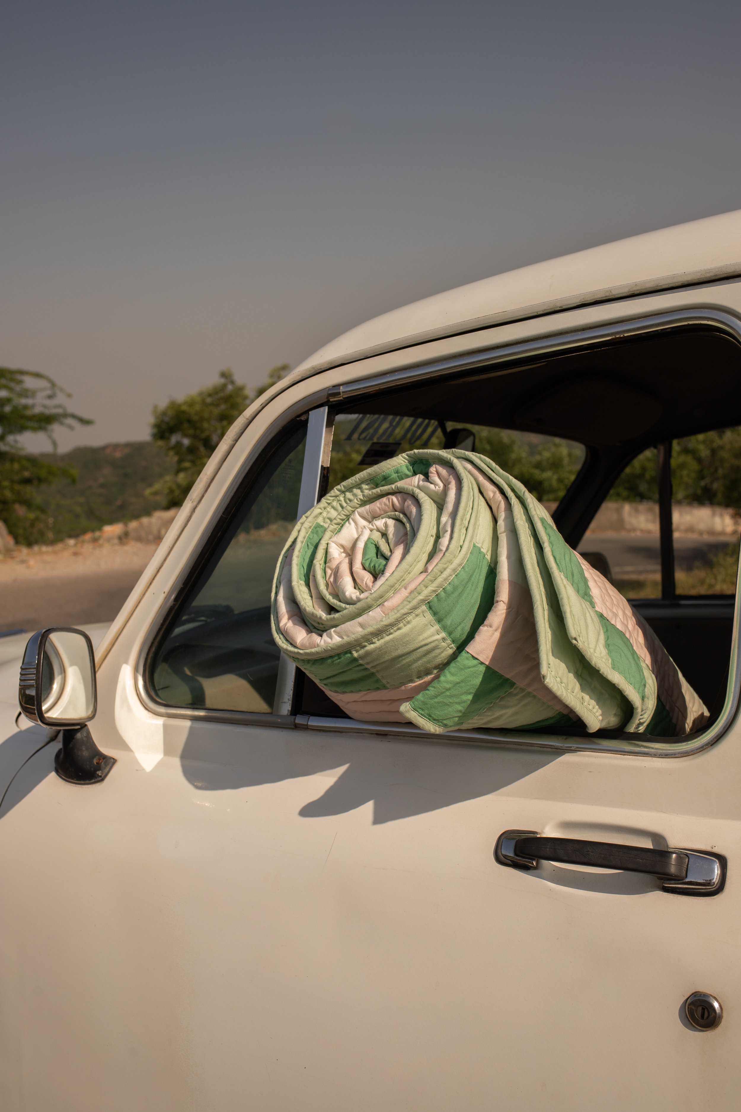 Shivani quilt propping up in the ambassador.