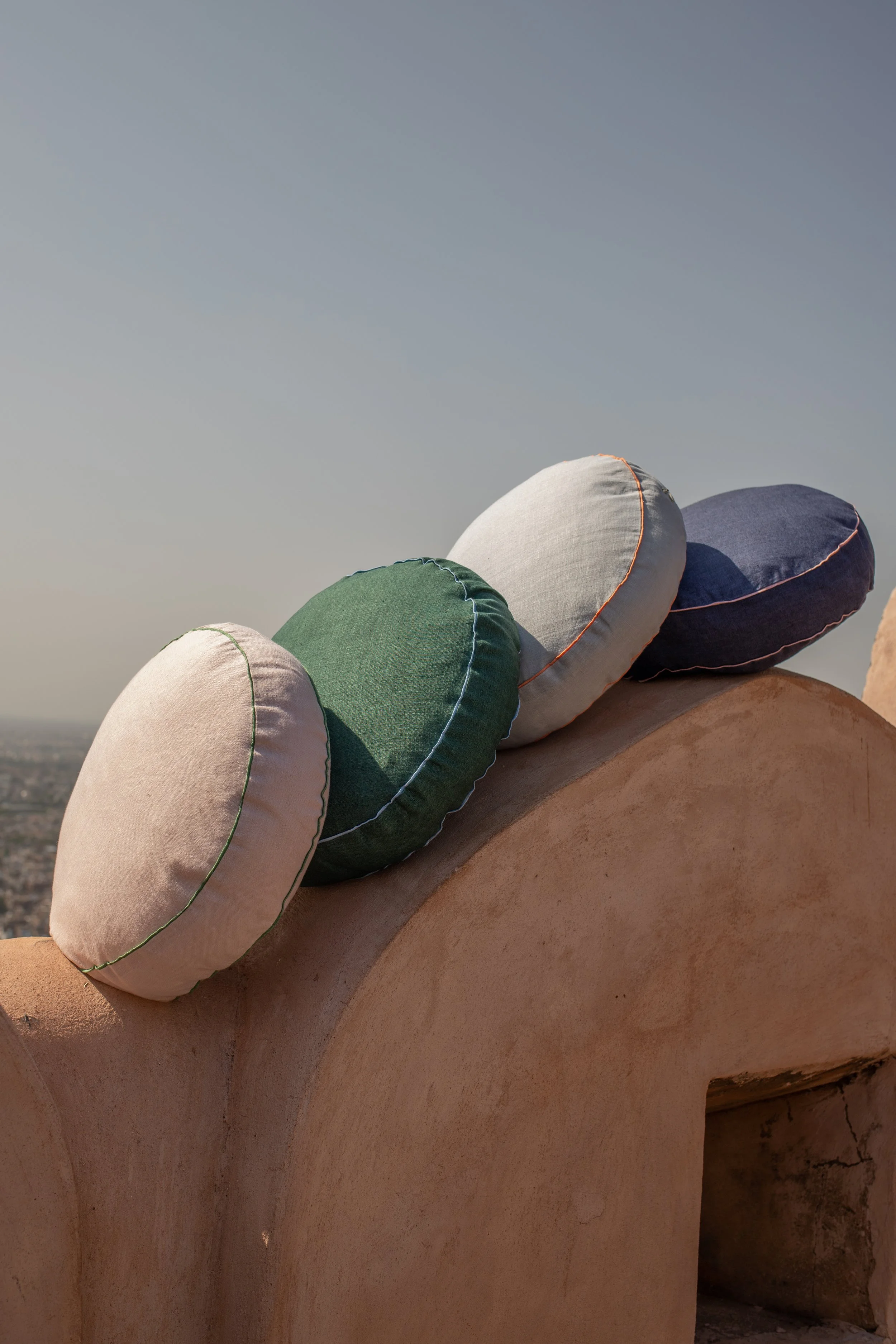 Round colourful cushions atop a fort in Jaipur.