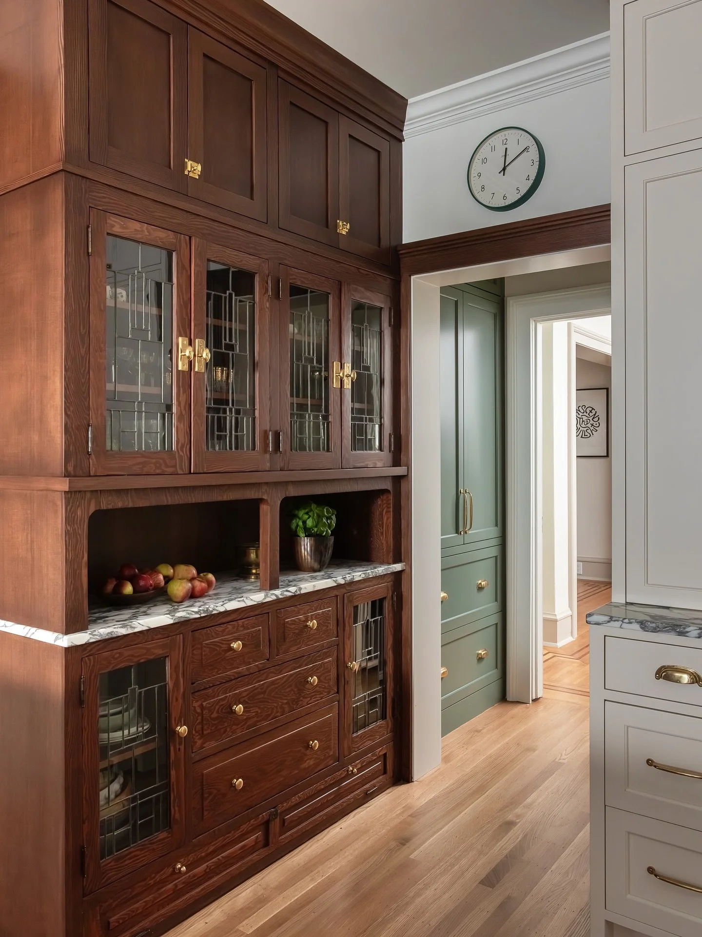 This cabinet, original to a 1920s craftsman, while obviously gorgeous, was built in to a dark wall in the dining room.  Incredible care was taken to remove, refinish, and rebuild with cabinetry added above.  It now shines as the first cabinet seen wa