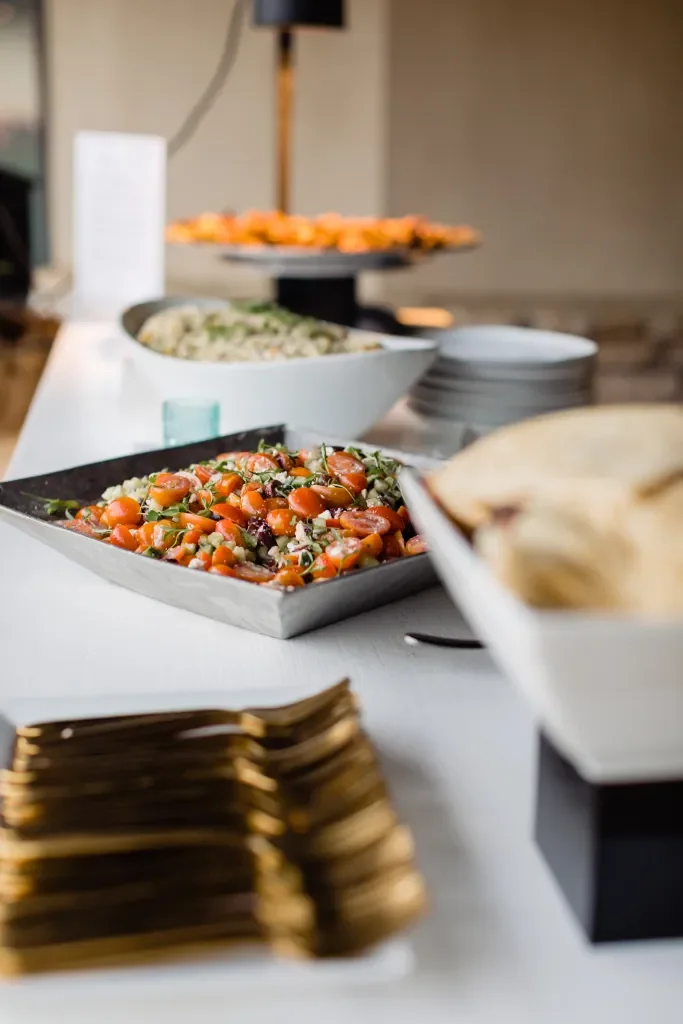 Assorted salads and finger foods on a buffet table.