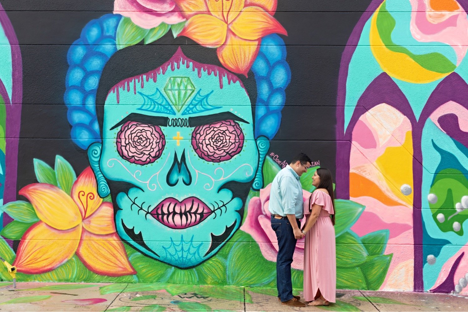 02_Wynwood-Walls-Engagement-Session-Miami-Engagement-Photographer_6402_posing_during_couple_in_walls_engagement_wynwood_hispanic_a_session_Mural_thier_of_front_Miami_photographer.jpg