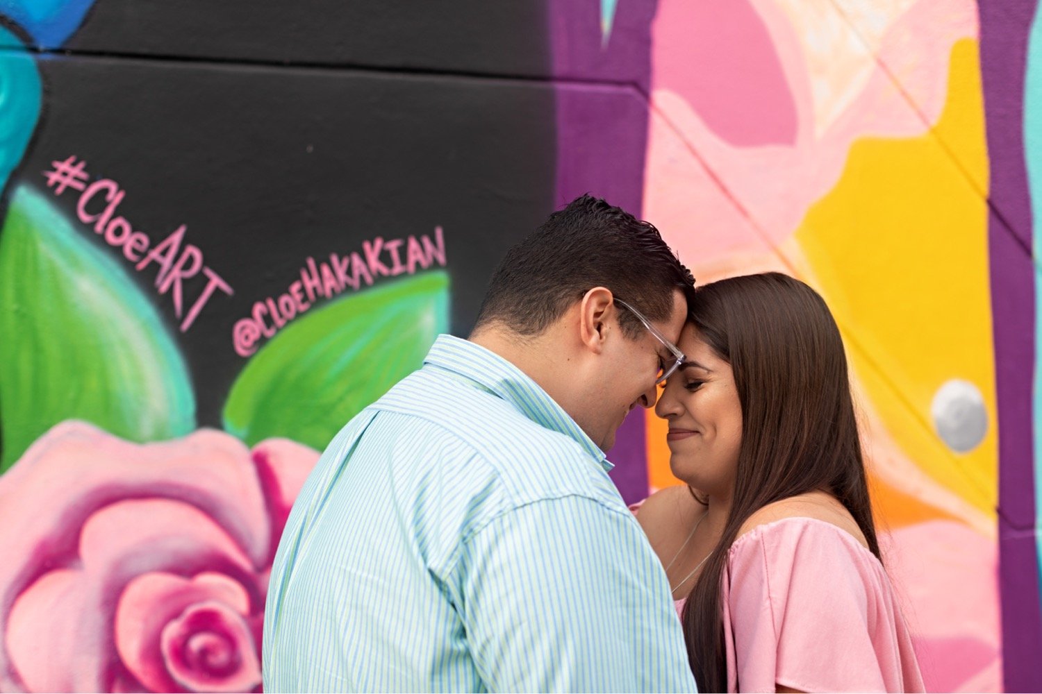 03_Wynwood-Walls-Engagement-Session-Miami-Engagement-Photographer_6408 1_posing_during_couple_in_walls_engagement_wynwood_hispanic_a_session_Mural_thier_of_front_Miami_photographer.jpg