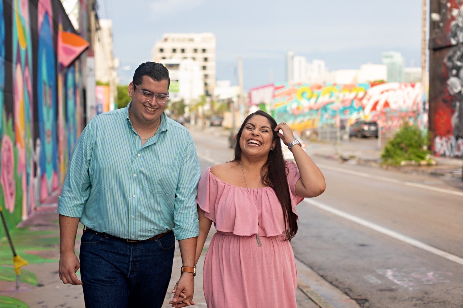 06_Wynwood-Walls-Engagement-Session-Miami-Engagement-Photographer_6476 1_posing_during_couple_in_walls_engagement_wynwood_hispanic_a_session_Mural_thier_of_front_Miami_photographer.jpg