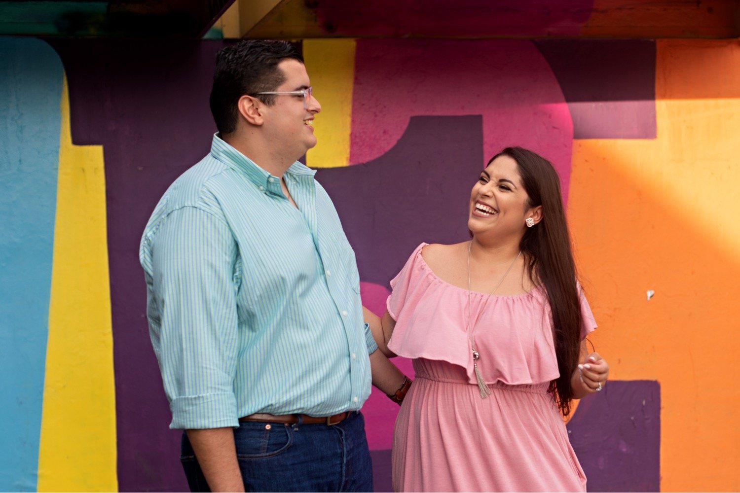 07_Wynwood-Walls-Engagement-Session-Miami-Engagement-Photographer_6589 1_posing_during_couple_in_walls_engagement_wynwood_hispanic_a_session_Mural_thier_of_front_Miami_photographer.jpg