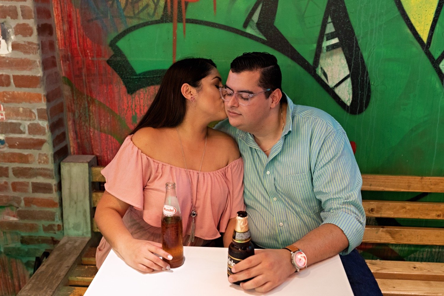 10_Wynwood-Walls-Engagement-Session-Miami-Engagement-Photographer_6725 1_during_couple_stand_eating_walls_wynwood_engagement_hispanic_session_at_taco_thier_the_Miami_photographer.jpg