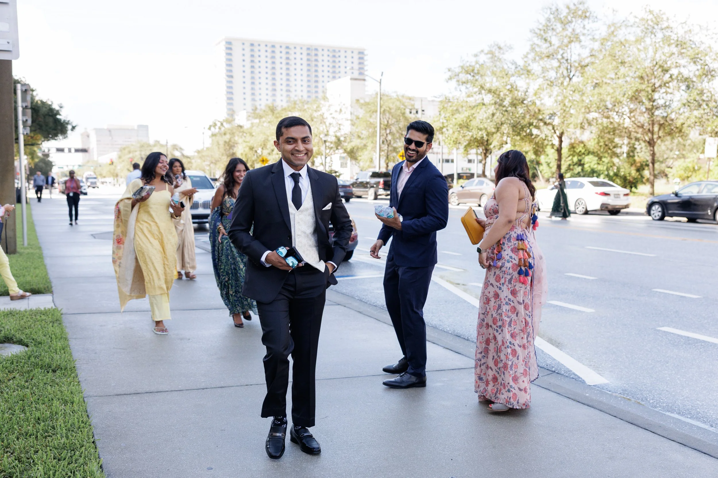 Couple and guests walking together outside the courthouse in South Florida before their wedding ceremony