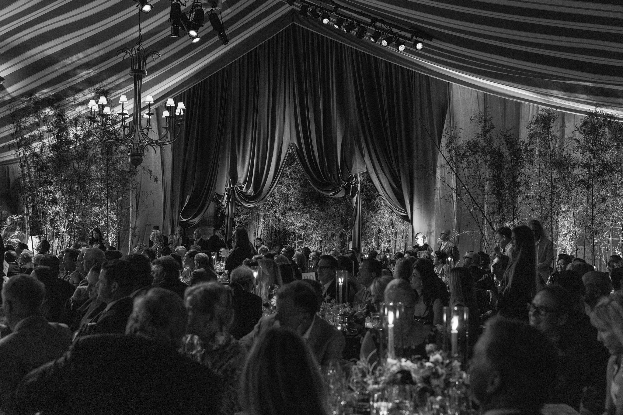 Guests attending a Palm Beach charity gala inside a tented event space