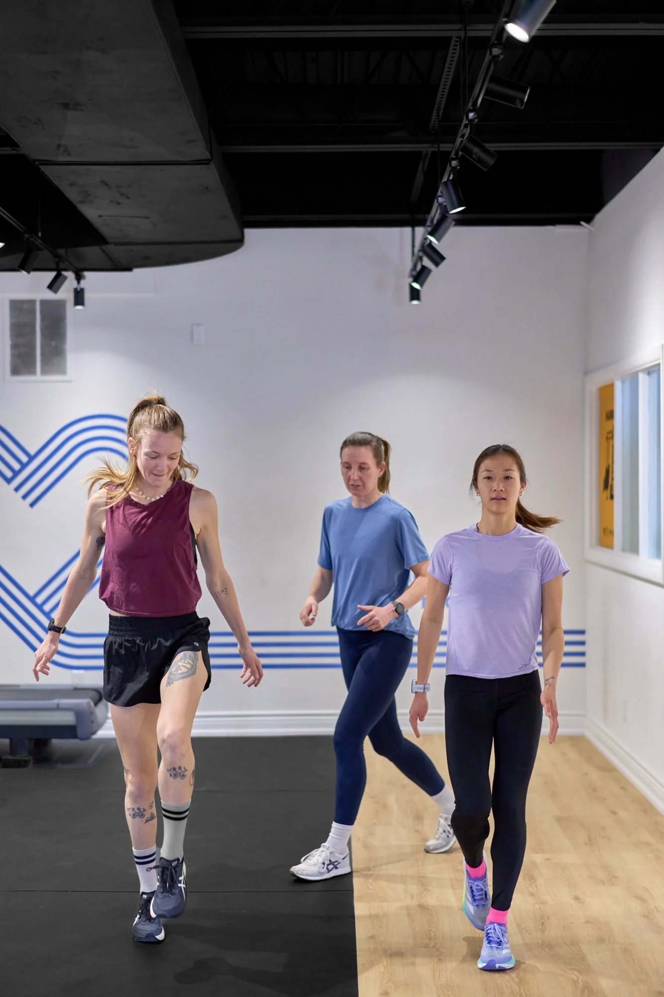 A physiotherapist running a group strength and conditioning program for runners