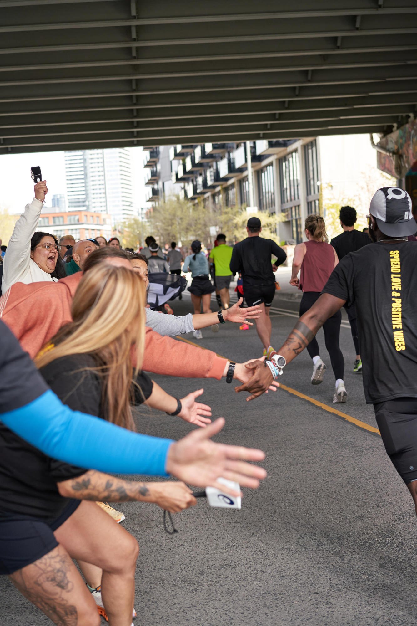 Runner's collecting high fives at the Toronto Waterfront Marathon