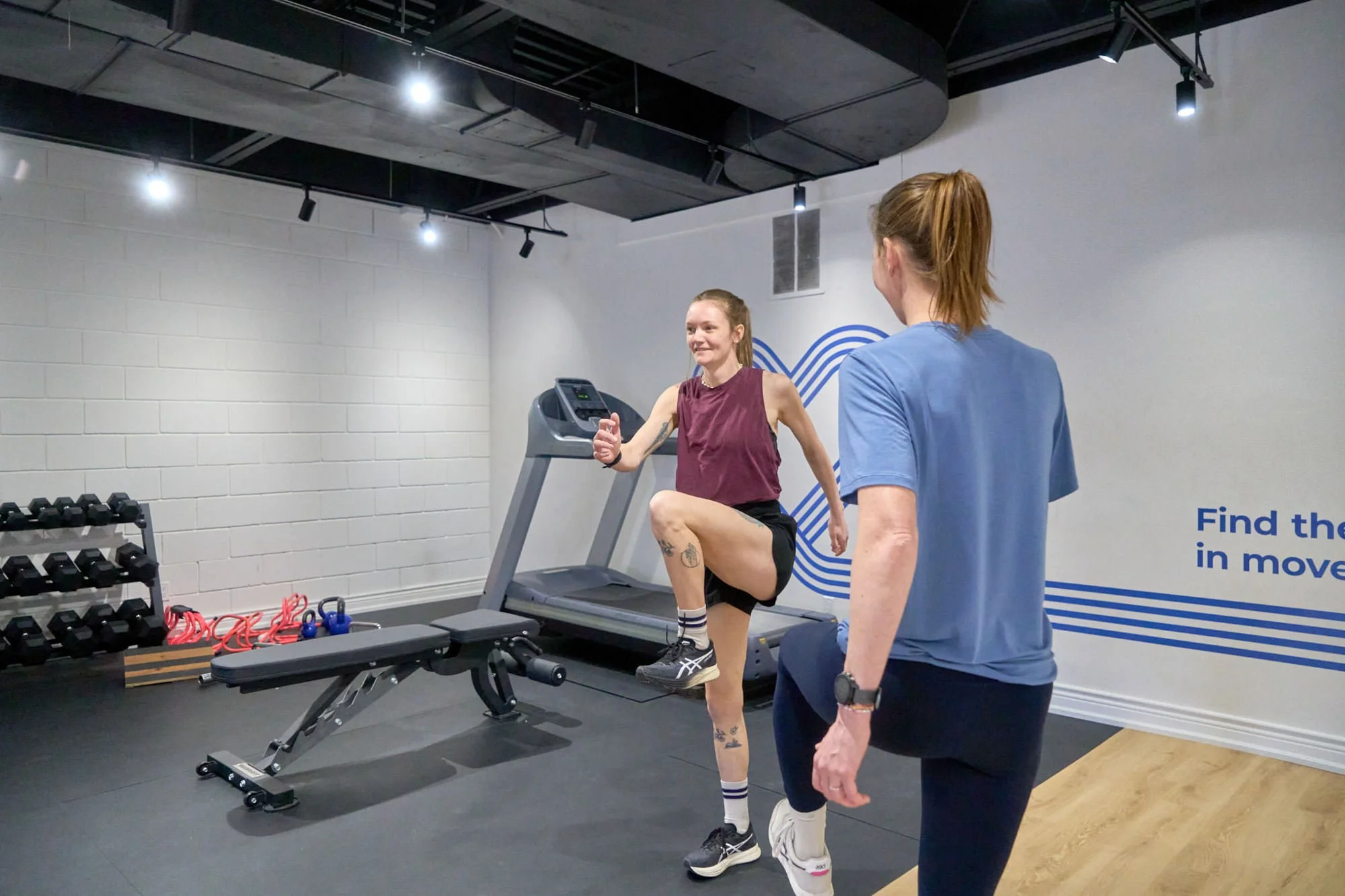 a physiotherapist working with a runner on form inside the clinic