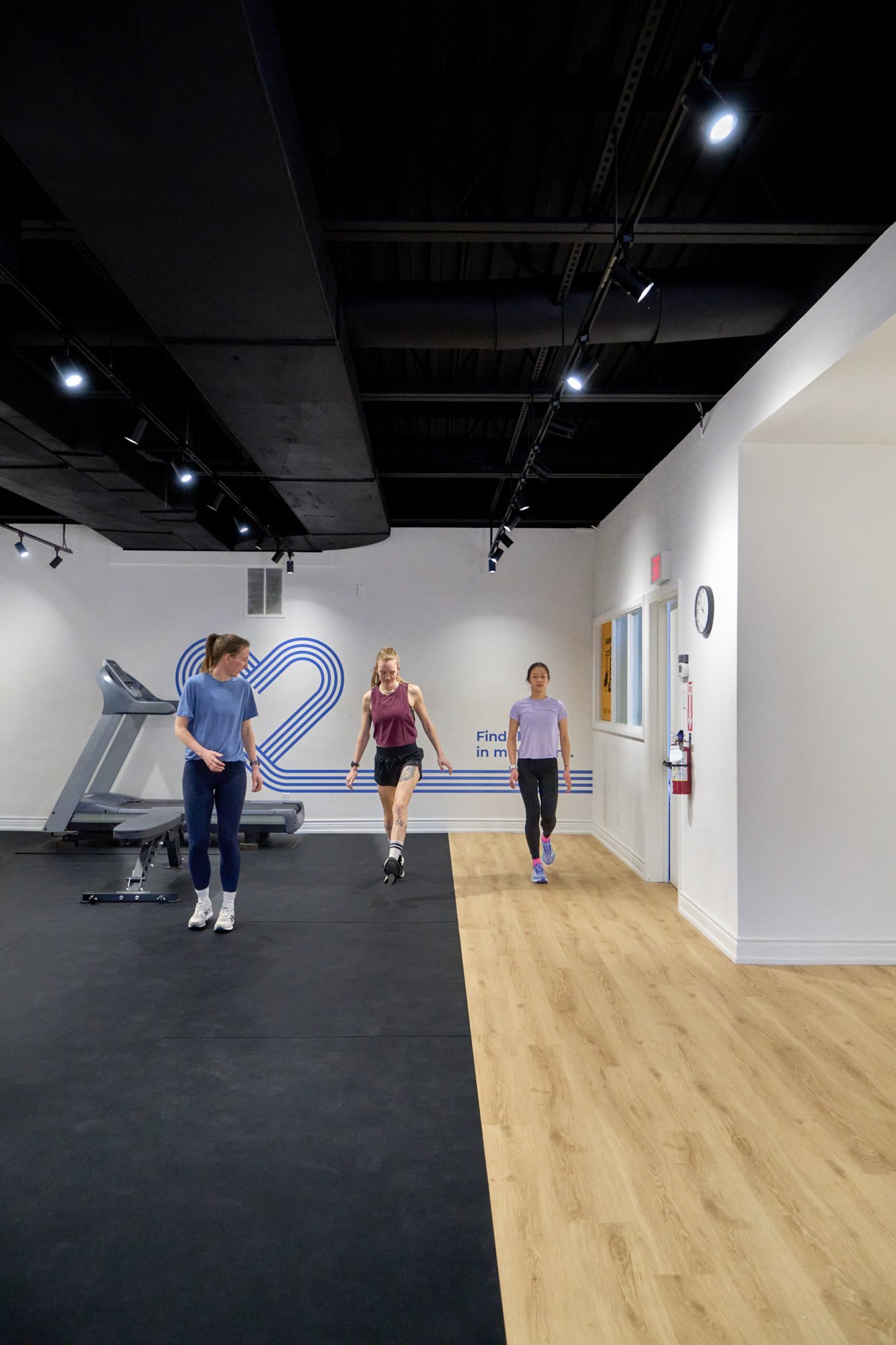 A physiotherapist leading a small group class for runners focused on strength and conditioning