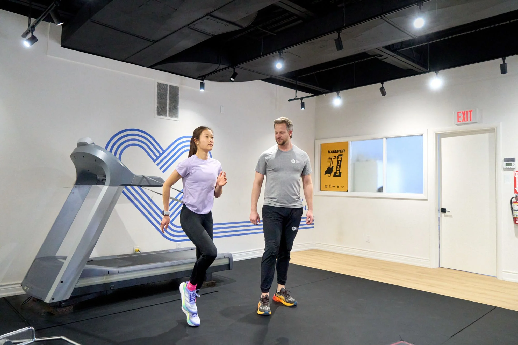 A physiotherapist working with a runner and optimizing her running form