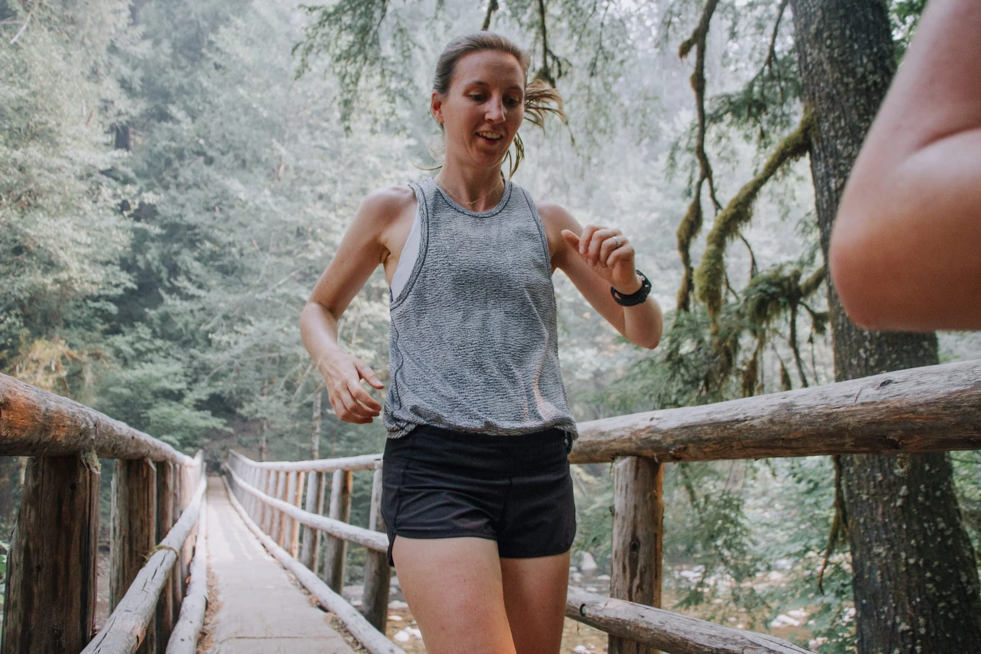 A runner running on a bridge outside
