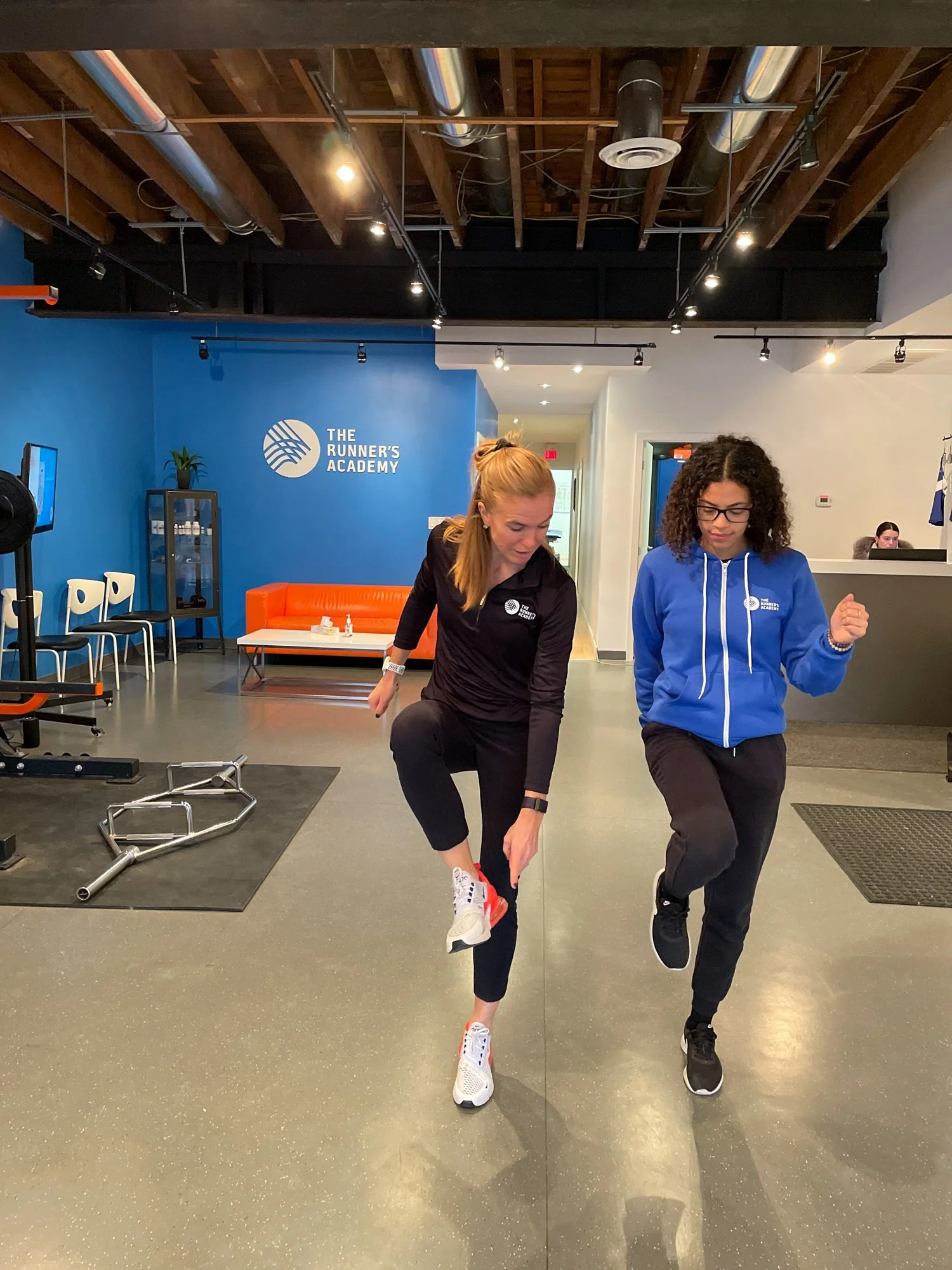 An athletic therapist working with a patient's running form