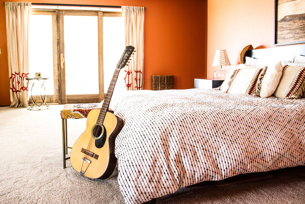 master bedroom with acoustic guitar