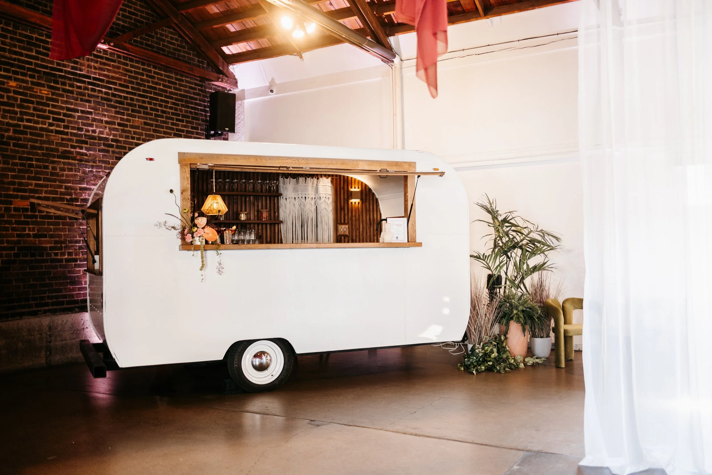 Modern vintage white cocktail camper by MinnyBar — a mobile bar for weddings, event planners, and brand activations in Minneapolis, Minnesota.
