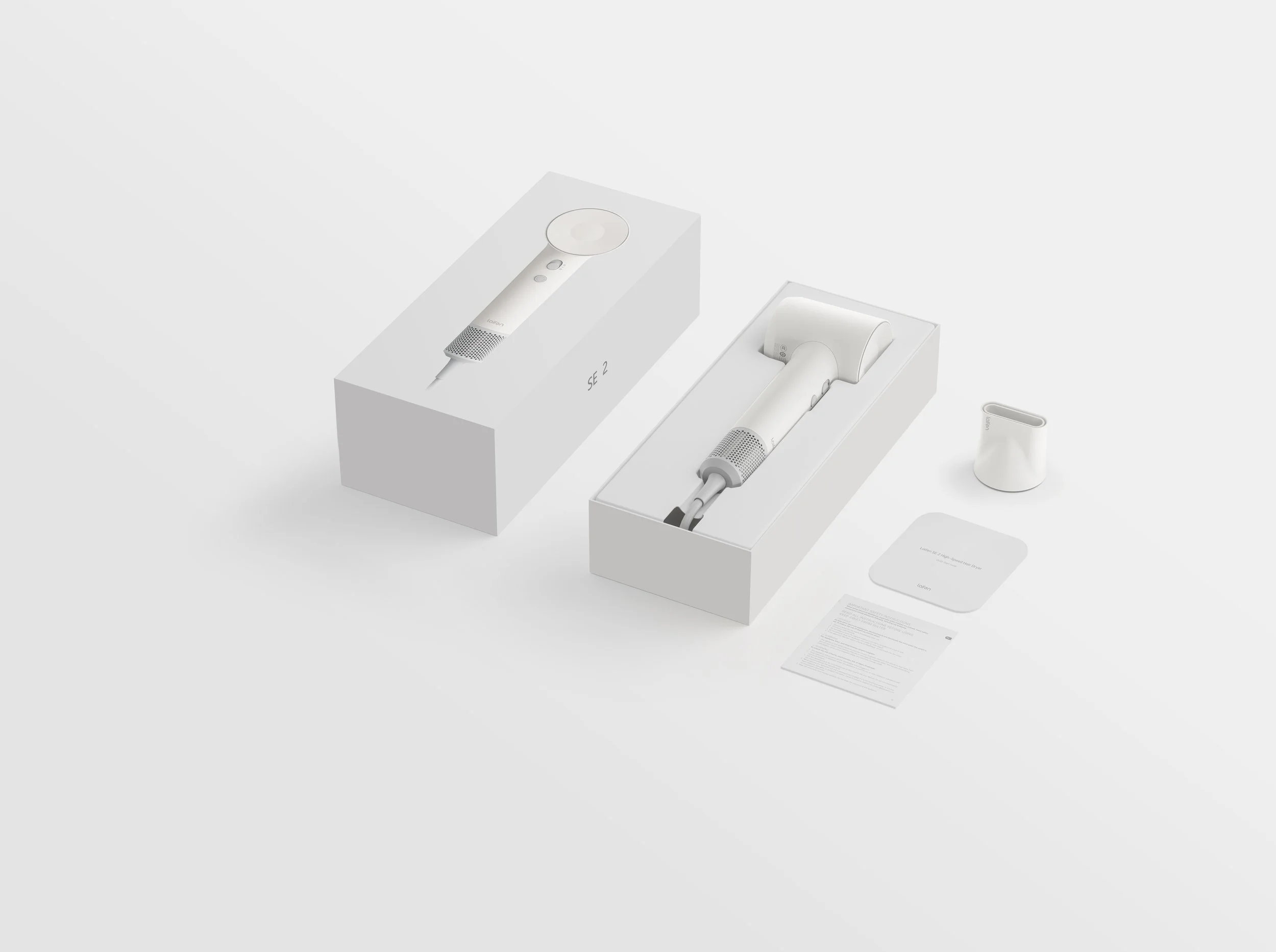 A set of two white hair styling tools in packaging with accessories and instruction sheet on a white background.