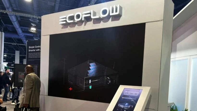 ECOFLOW exhibition booth with a large black display screen and a white touchscreen kiosk at a trade show.