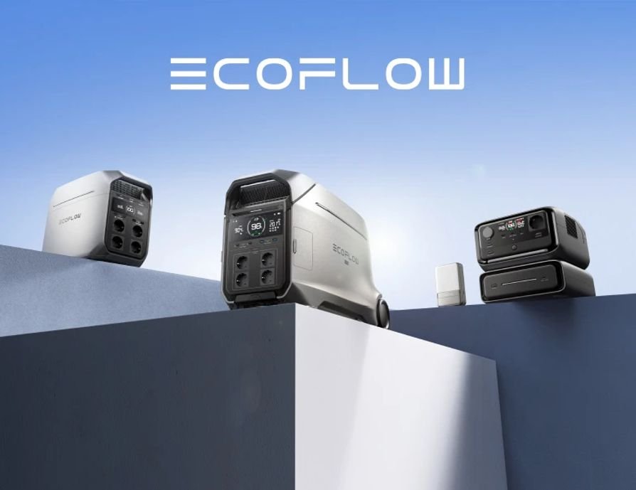 Four portable power stations or batteries with digital displays, some connected to charging devices, arranged on platforms against a blue sky background with the brand name 'ECOFLOW' at the top.