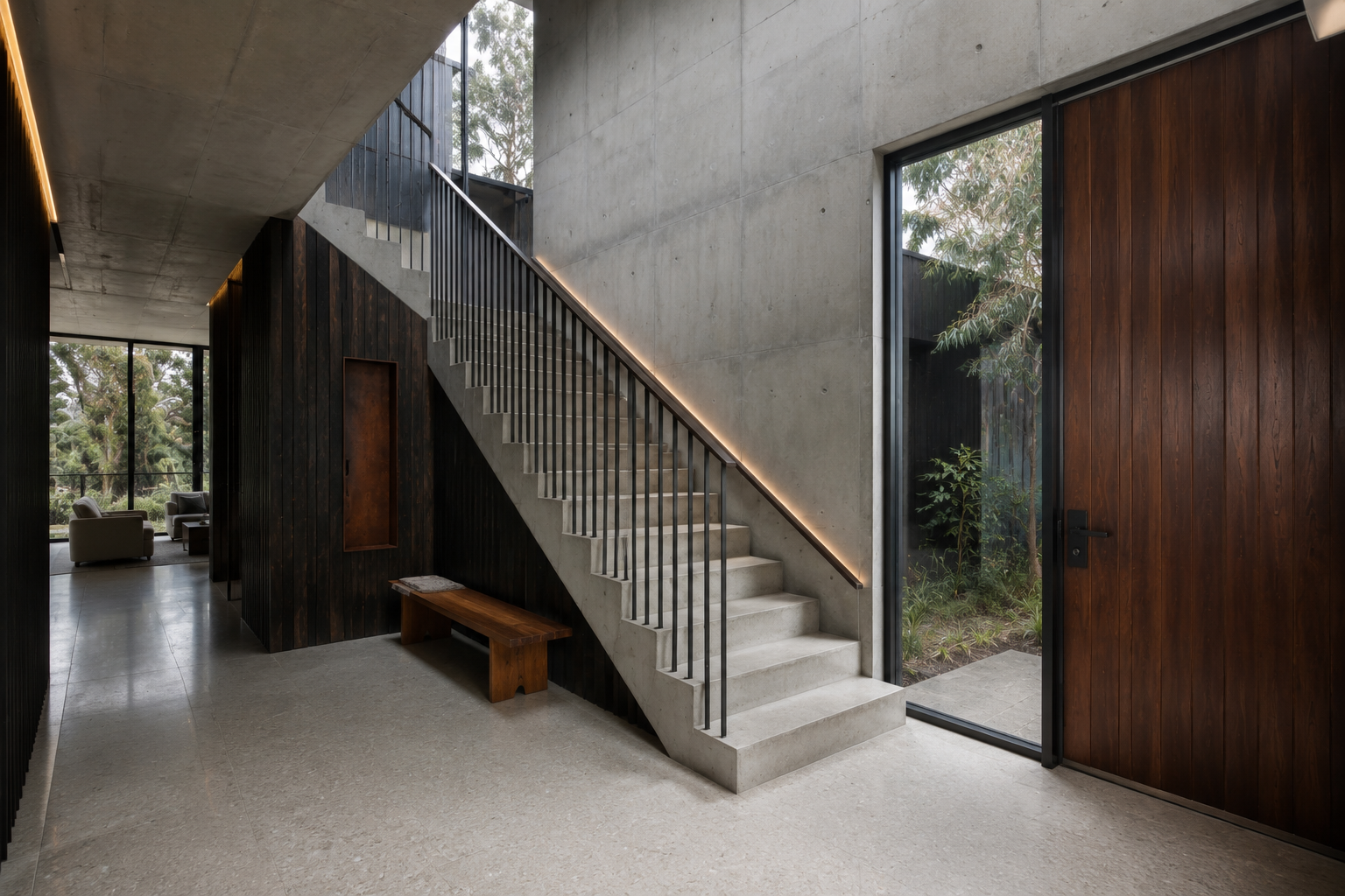Concrete staircase with dark timber walls, integrated lighting and views into a planted courtyard.