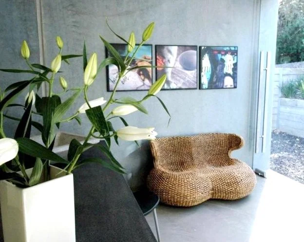 Minimalist interior of an architectural concrete home featuring polished concrete floors, natural light and calm living spaces