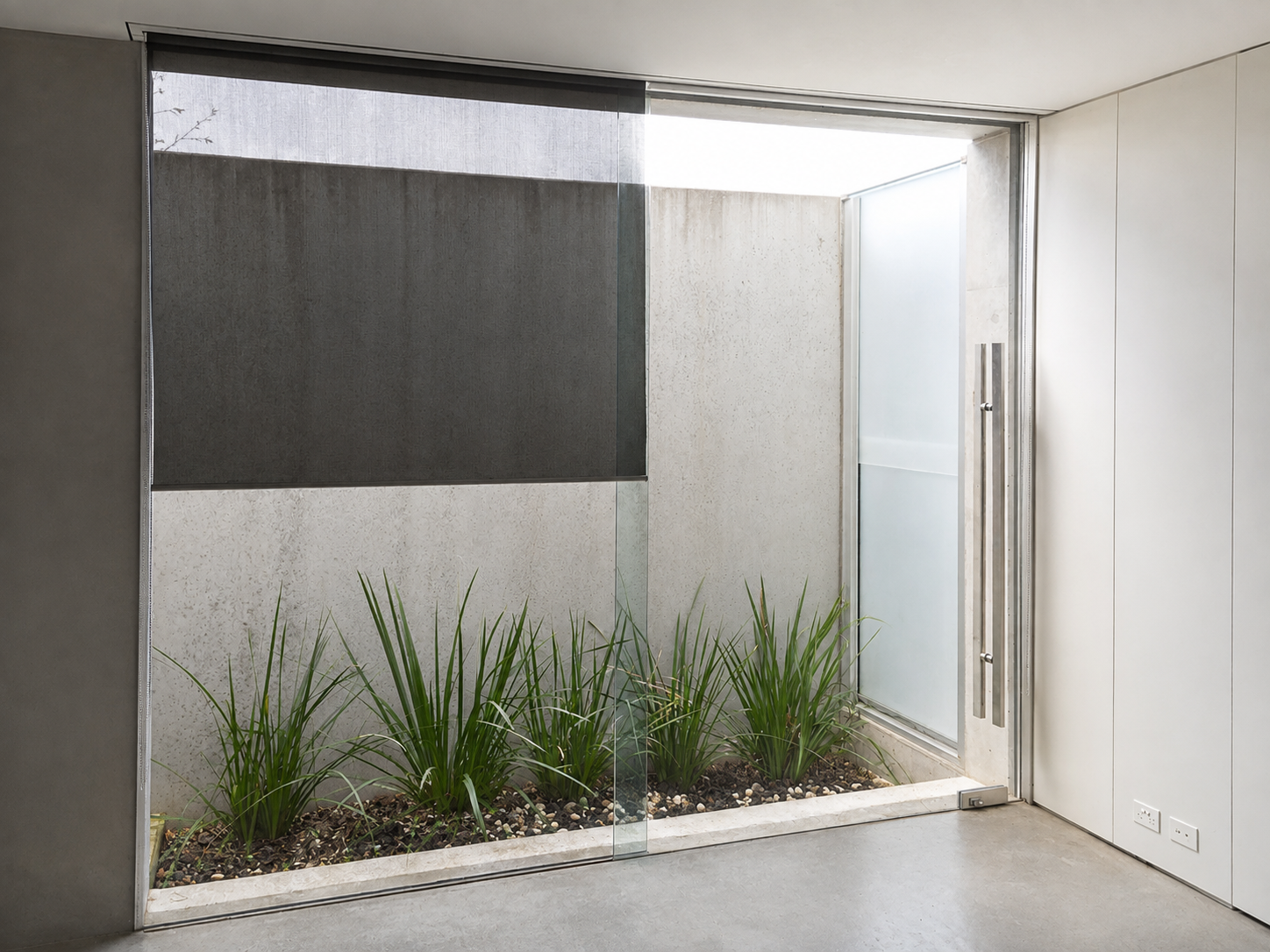 Internal landscaped courtyard with concrete walls and full-height glazing in a COAD88 Alphington home